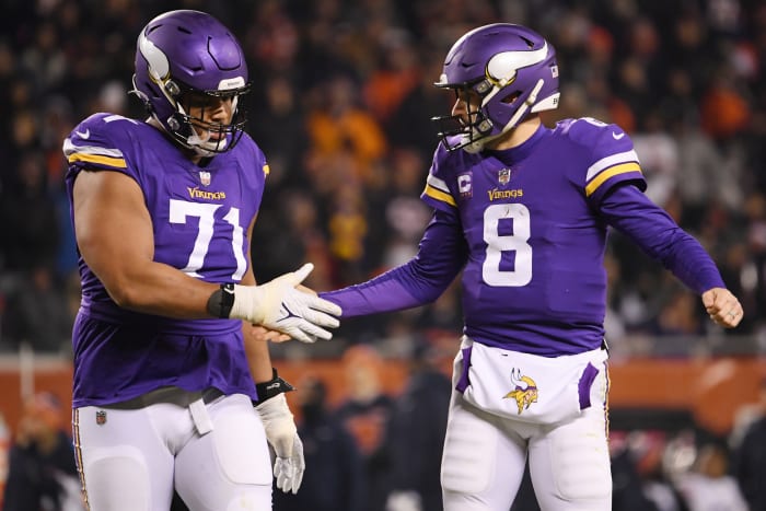 Kirk Cousins and Christian Darrisaw high five each other